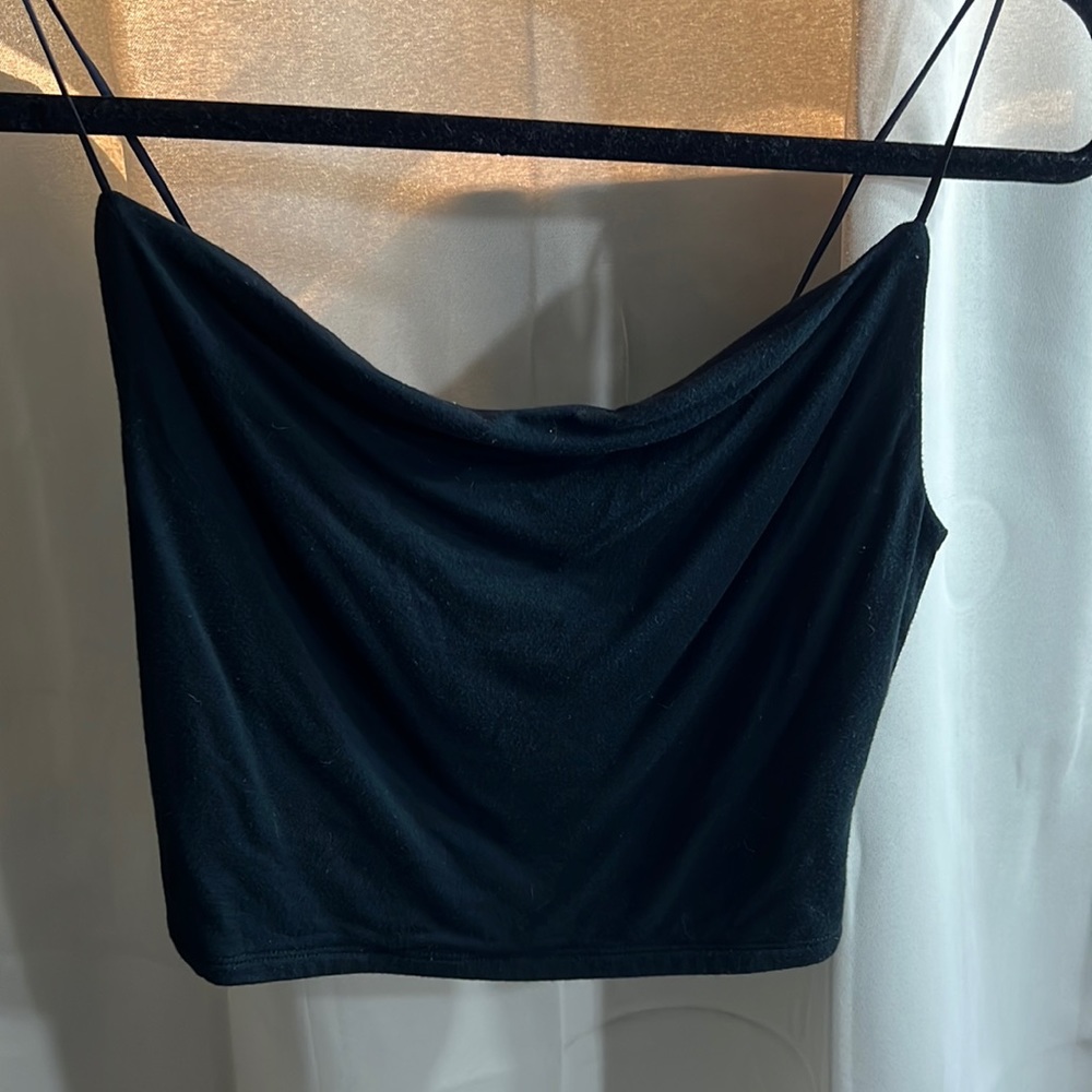 A cropped scoop neck black tank top. Never worn and super cute!